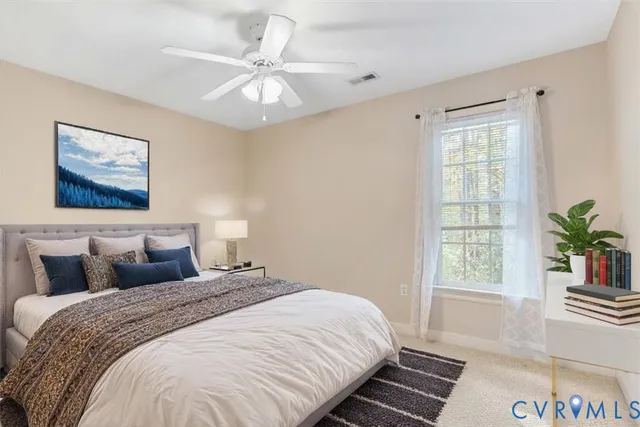 a bedroom with a large bed and a window