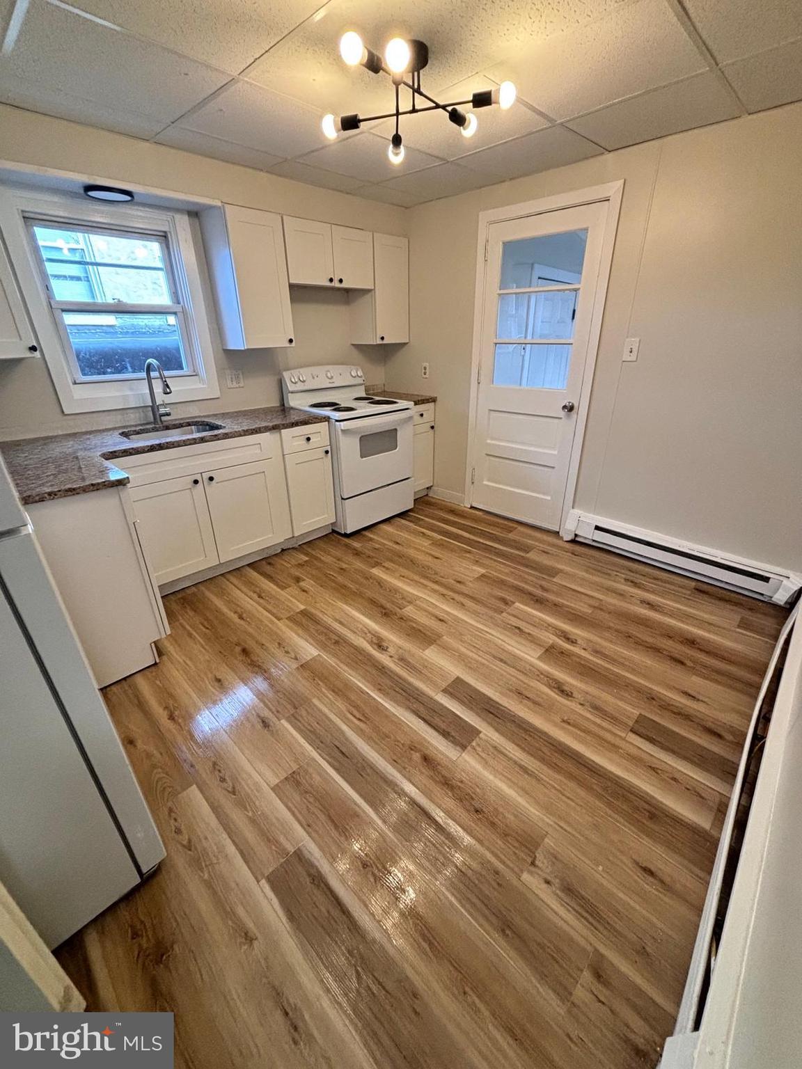 343 Chestnut Street Reading, PA 19602 - Photo 3 of 16 a kitchen with granite countertop a sink stainless steel appliances and cabinets