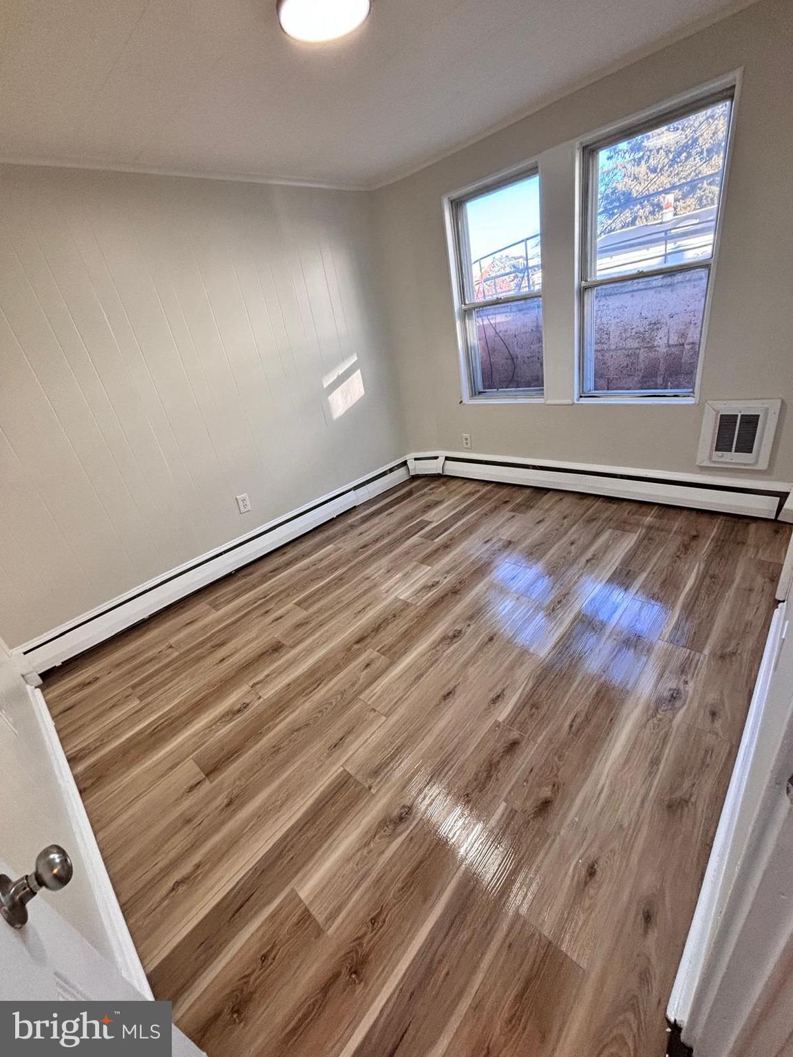 343 Chestnut Street Reading, PA 19602 - Photo 5 of 16 an empty room with wooden floor and windows