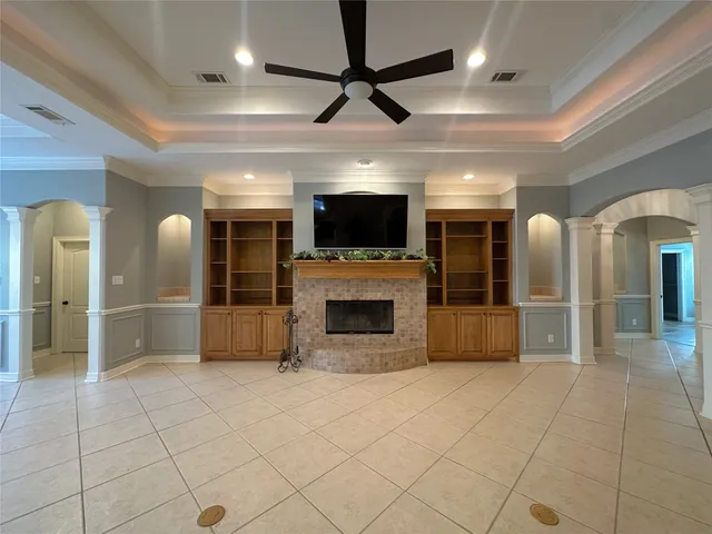 a view of an empty room with window and cabinet