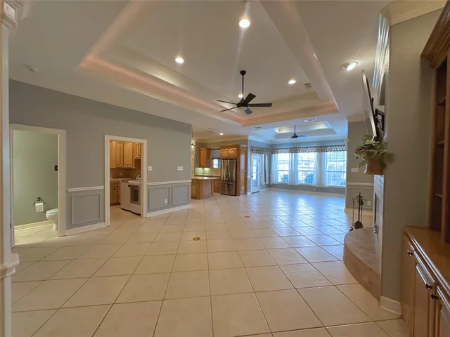 a view of a livingroom with fireplace and a chandelier