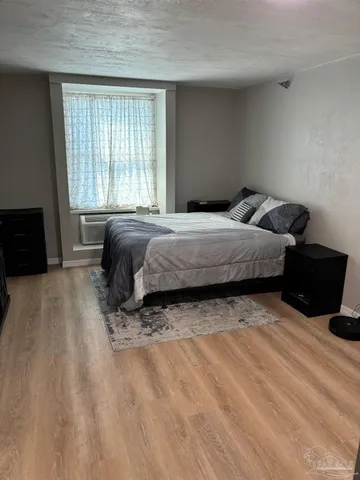a bedroom with a bed and a couch