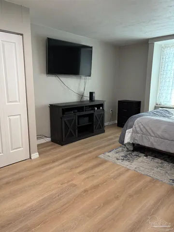 a bedroom with a bed and a flat screen tv