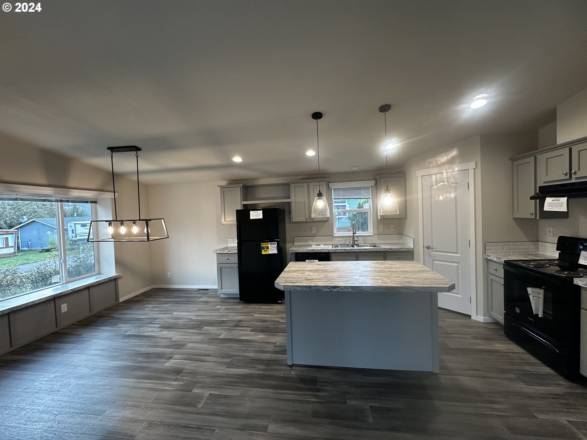 644 Main Street Yoncalla, OR 97499 - Photo 12 of 29 a kitchen with kitchen island a counter top space a stove and cabinets
