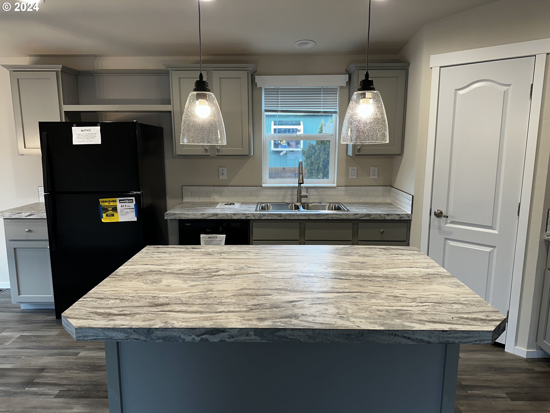 644 Main Street Yoncalla, OR 97499 - Photo 13 of 29 a kitchen with kitchen island stainless steel appliances and wooden floor