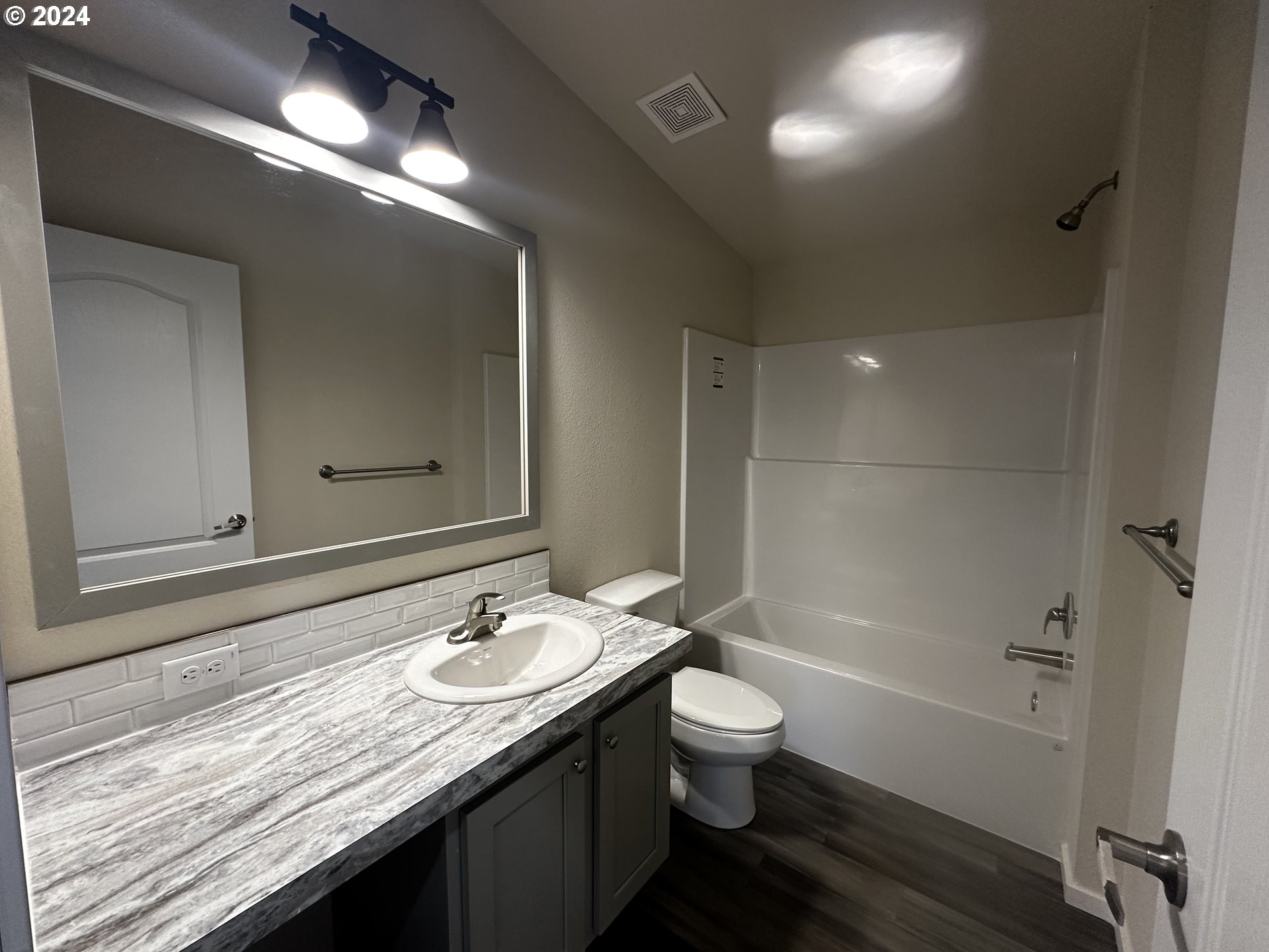 644 Main Street Yoncalla, OR 97499 - Photo 18 of 29 a bathroom with a granite countertop sink a toilet and shower