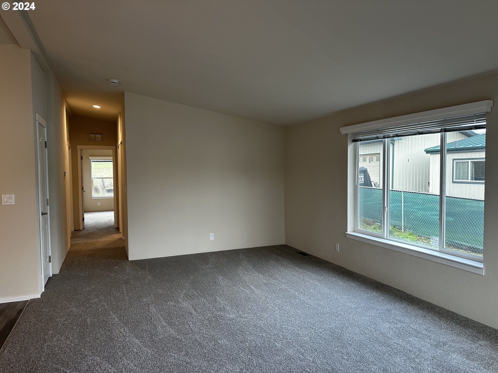 644 Main Street Yoncalla, OR 97499 - Photo 5 of 29 an empty room with windows and entrance