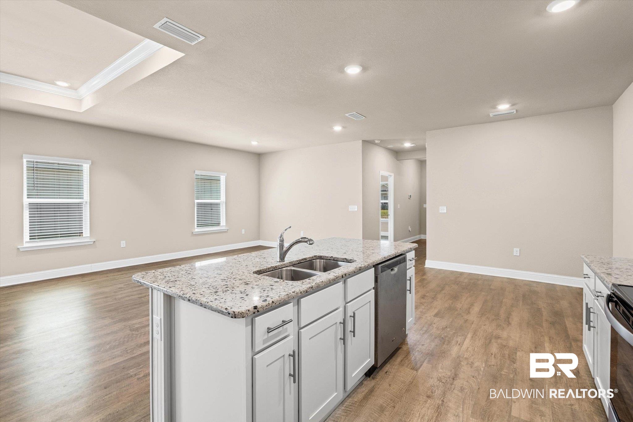 22976 Lieutenant Avenue Foley, AL 36535 - Photo 29 of 30 Kitchen featuring recessed lighting, light stone counters, open floor plan, an island with sink, and light wood finished floors