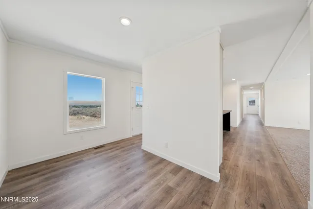 a view of an empty room and wooden floor
