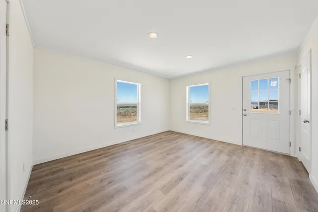 a view of empty room with wooden floor