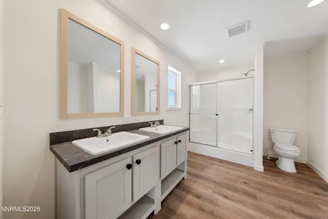 a bathroom with a granite countertop sink mirror and toilet