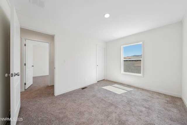 an empty room with a empty space and windows