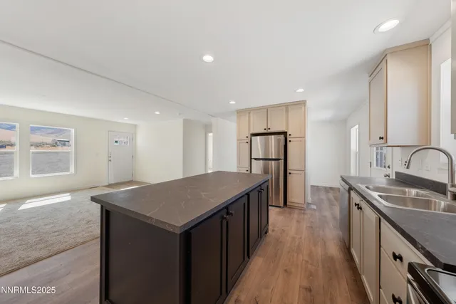 a kitchen with kitchen island a sink stove and refrigerator
