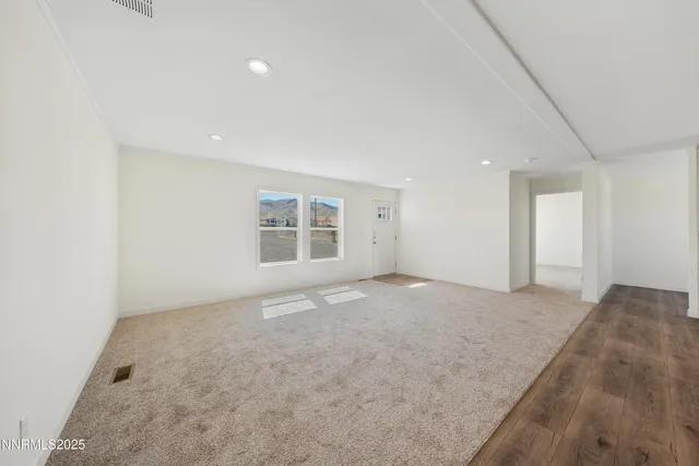 an empty room with a empty space and windows