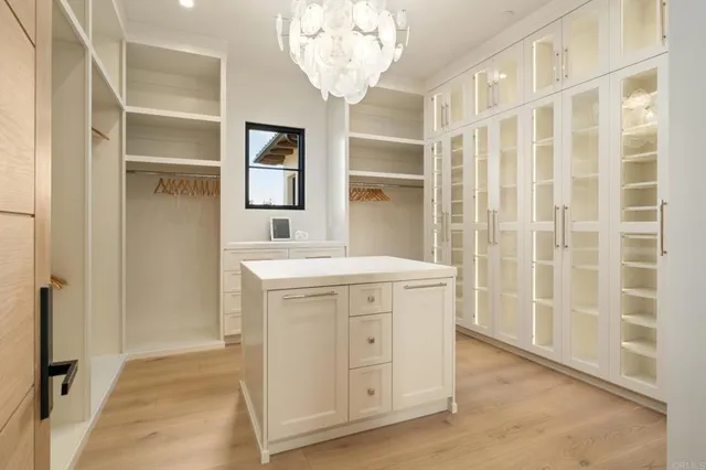 an entryway with a cabinet and a mirror