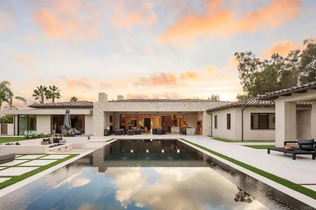 a view of a swimming pool with outdoor seating