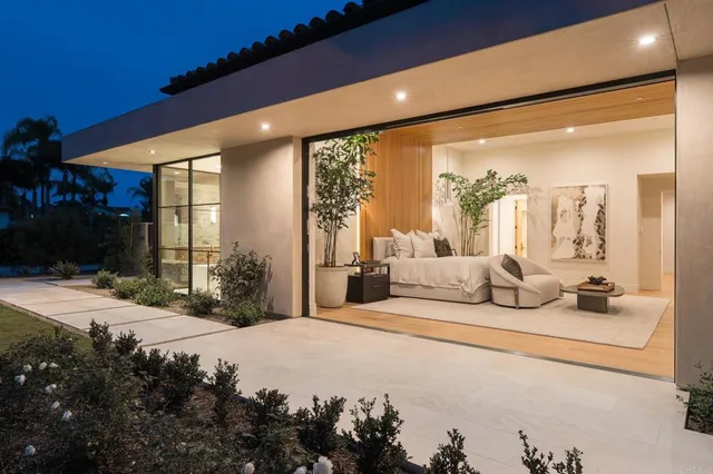 a spacious bedroom with a large bed and a large window