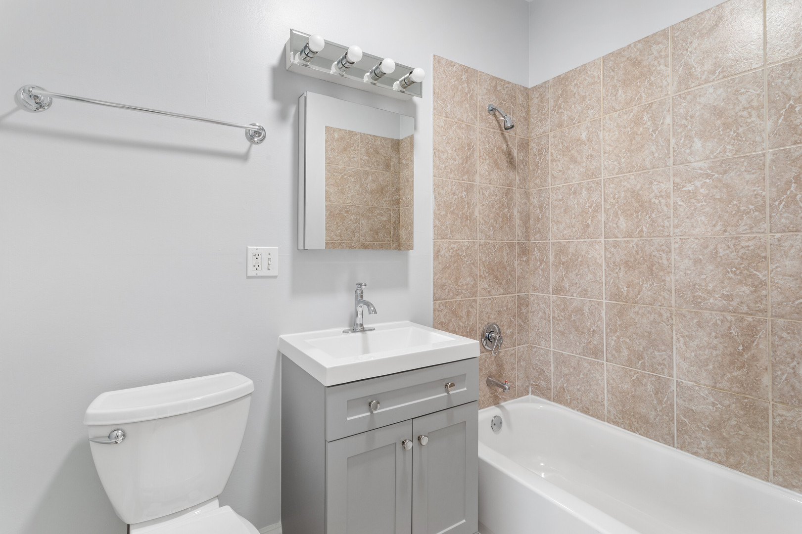 7322 North Damen Avenue, Unit 3 Chicago, IL 60645 - Photo 12 of 16 a bathroom with a sink a toilet and shower