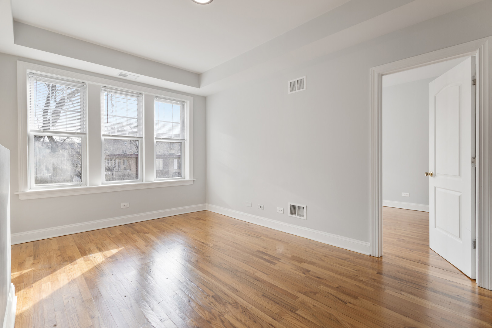 7322 North Damen Avenue, Unit 3 Chicago, IL 60645 - Photo 6 of 16 a view of empty room with wooden floor and fan