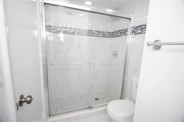 a kitchen with stainless steel appliances granite countertop a stove a microwave and a white cabinets