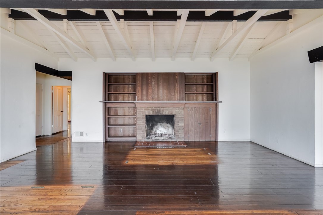 1811 Ocean Way Laguna Beach, CA 92651 - Photo 13 of 28 a view of an empty room with wooden floor fireplace and a window