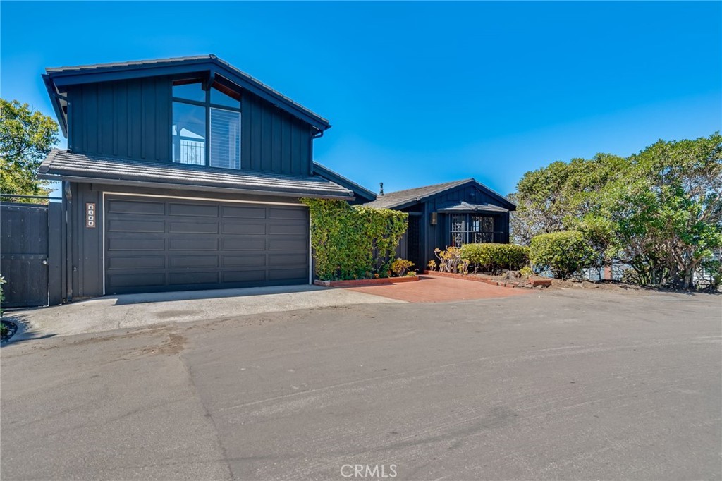 1811 Ocean Way Laguna Beach, CA 92651 - Photo 26 of 28 a front view of a house with a yard and garage