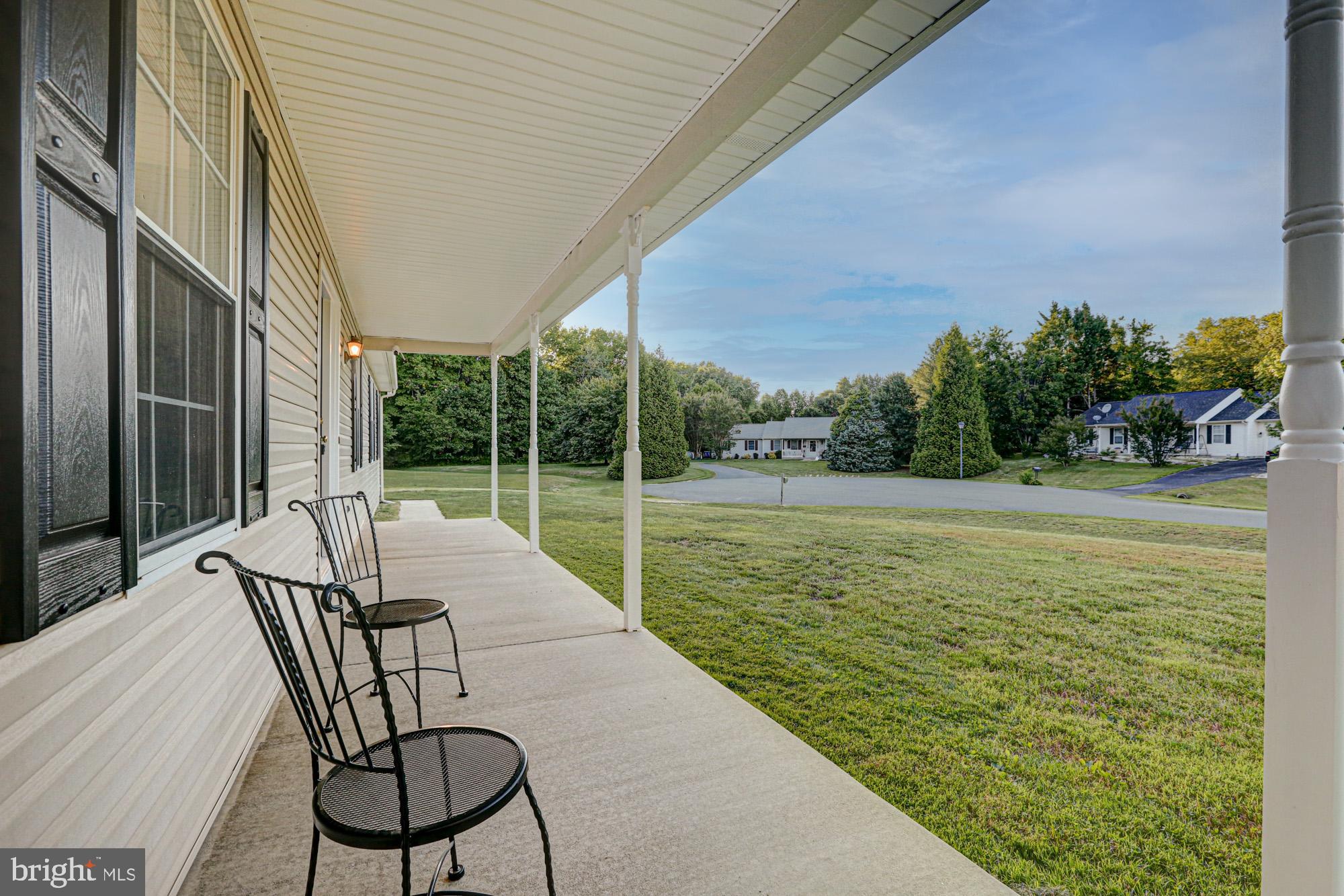 230 Tina Marie Lane Smyrna, DE 19977 - Photo 14 of 83 a view of a patio with a table chairs and garden