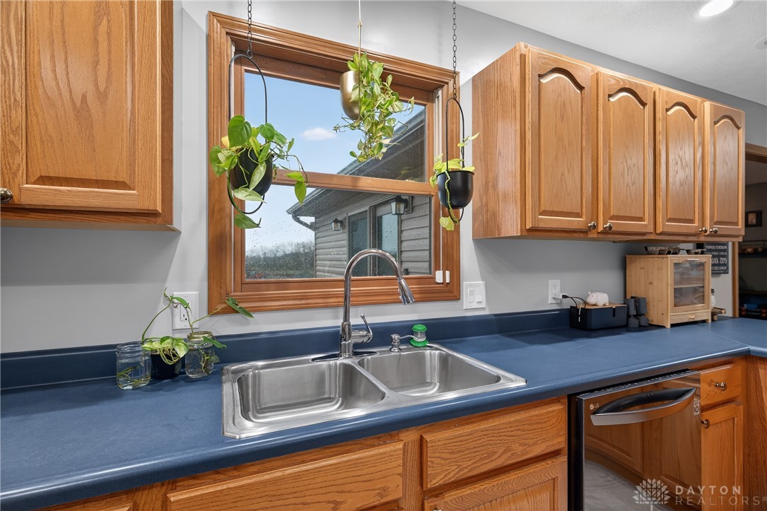 5264 Frazier-Guy Road Sidney, OH 45365 - Photo 14 of 51 This bright kitchen features a double sink and ample cabinetry, offering functional design.