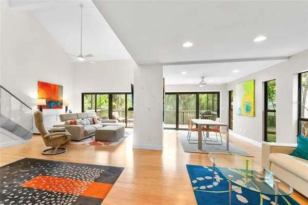 a living room with furniture and a floor to ceiling window