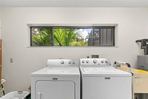 a bathroom with a sink a toilet a shower and a mirror