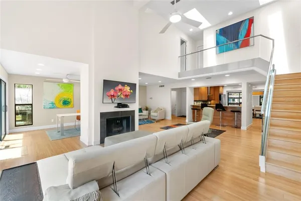 a living room with fireplace furniture and a large window