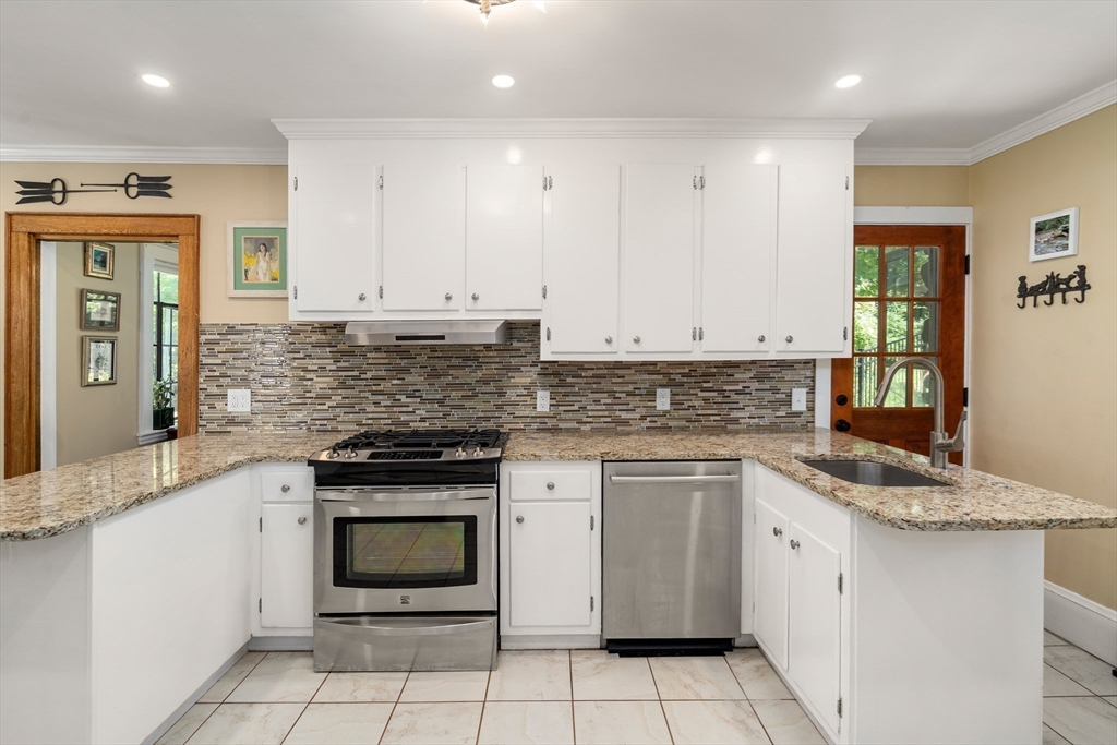 63 Crabtree Road Quincy, MA 02171 - Photo 29 of 41 a kitchen with granite countertop white cabinets and white stainless steel appliances