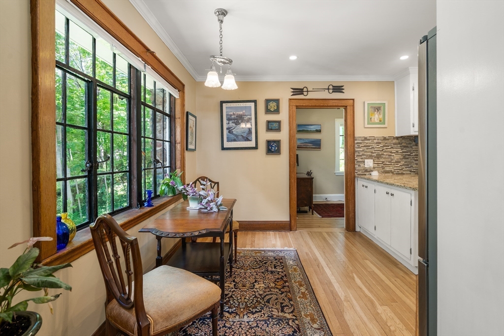 63 Crabtree Road Quincy, MA 02171 - Photo 30 of 41 a dining room with furniture a chandelier and wooden floor