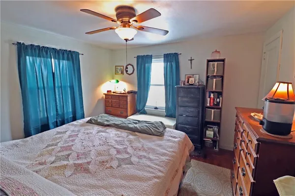 a bedroom with a bed and a television