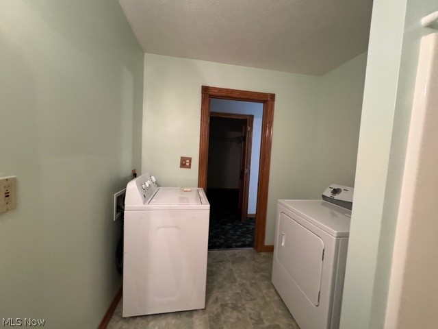 6900 North Ridge Road East Geneva, OH 44041 - Photo 20 of 37 Clothes washing area with washing machine and clothes dryer and tile patterned floors
