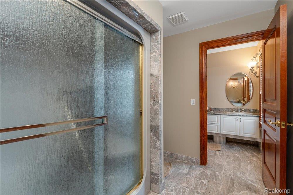 3543 Cedar Brook Drive Rochester, MI 48309 - Photo 78 of 99 Shower enclosure with textured glass and brass-tone framing