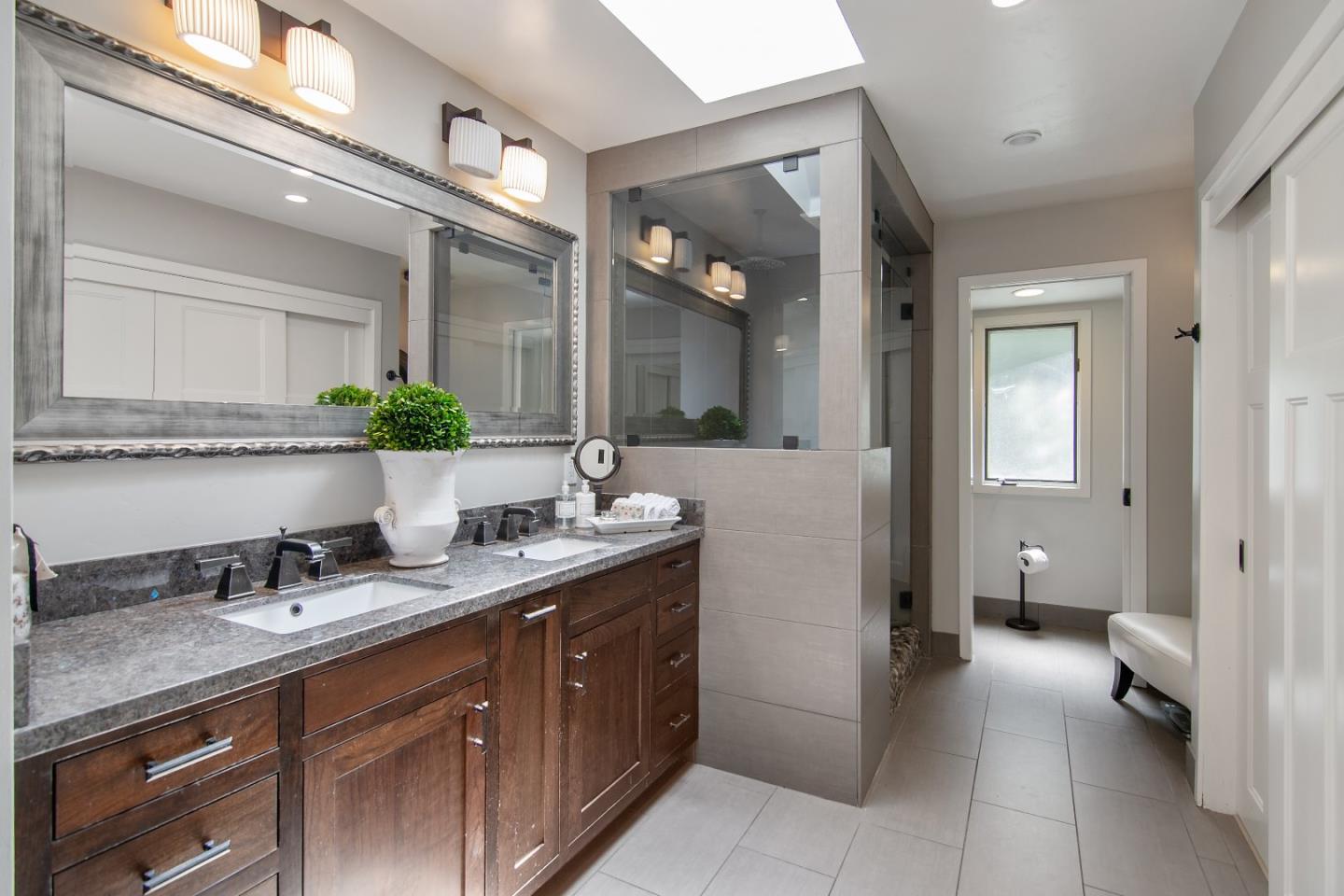 14973 Natalye Road Monte Sereno, CA 95030 - Photo 20 of 31 a spacious bathroom with a granite countertop sink a toilet and a mirror