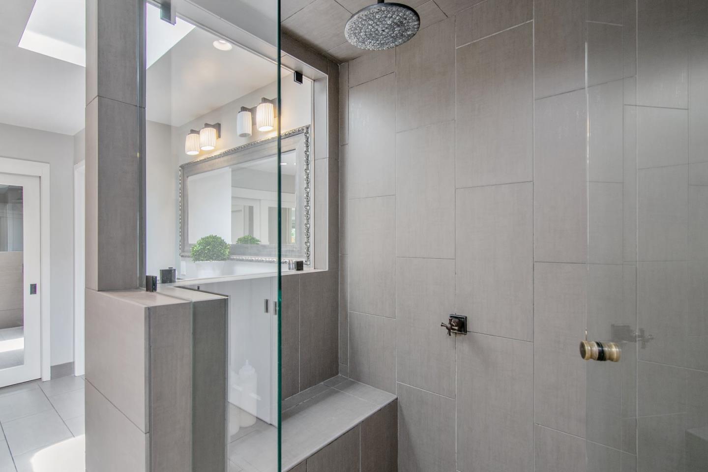 14973 Natalye Road Monte Sereno, CA 95030 - Photo 21 of 31 a bathroom with a granite countertop sink a mirror and a shower
