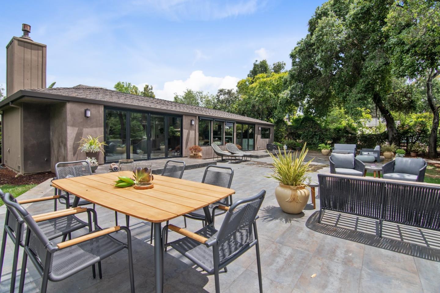 14973 Natalye Road Monte Sereno, CA 95030 - Photo 26 of 31 a view of a patio with a dining table and chairs with wooden floor