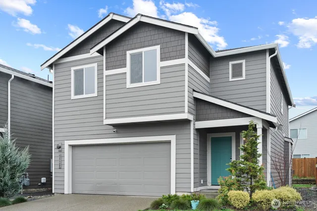 a front view of a house with garage