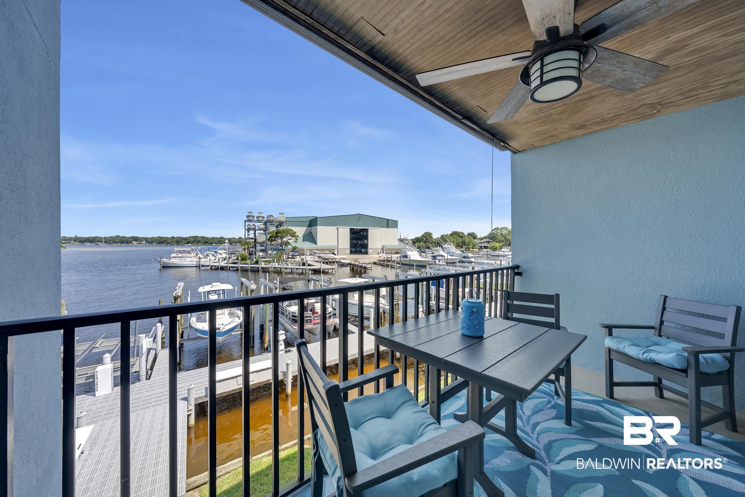 14100 River Road, Unit 211 Pensacola, FL 32507 - Photo 21 of 56 Balcony overlooking a marina with multiple boats and docks