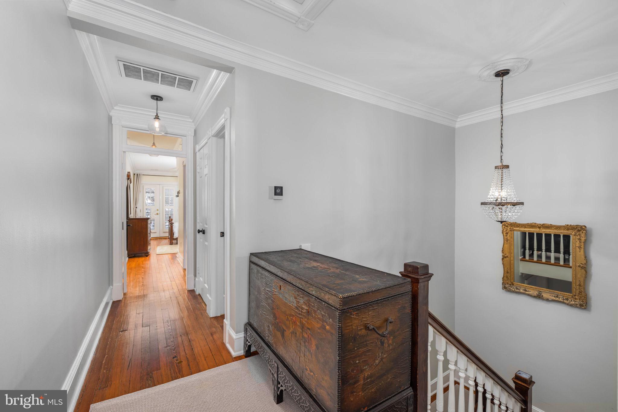 3408 Dent Place Northwest Washington, DC 20007 - Photo 11 of 17 a view of a hallway with wooden floor and staircase