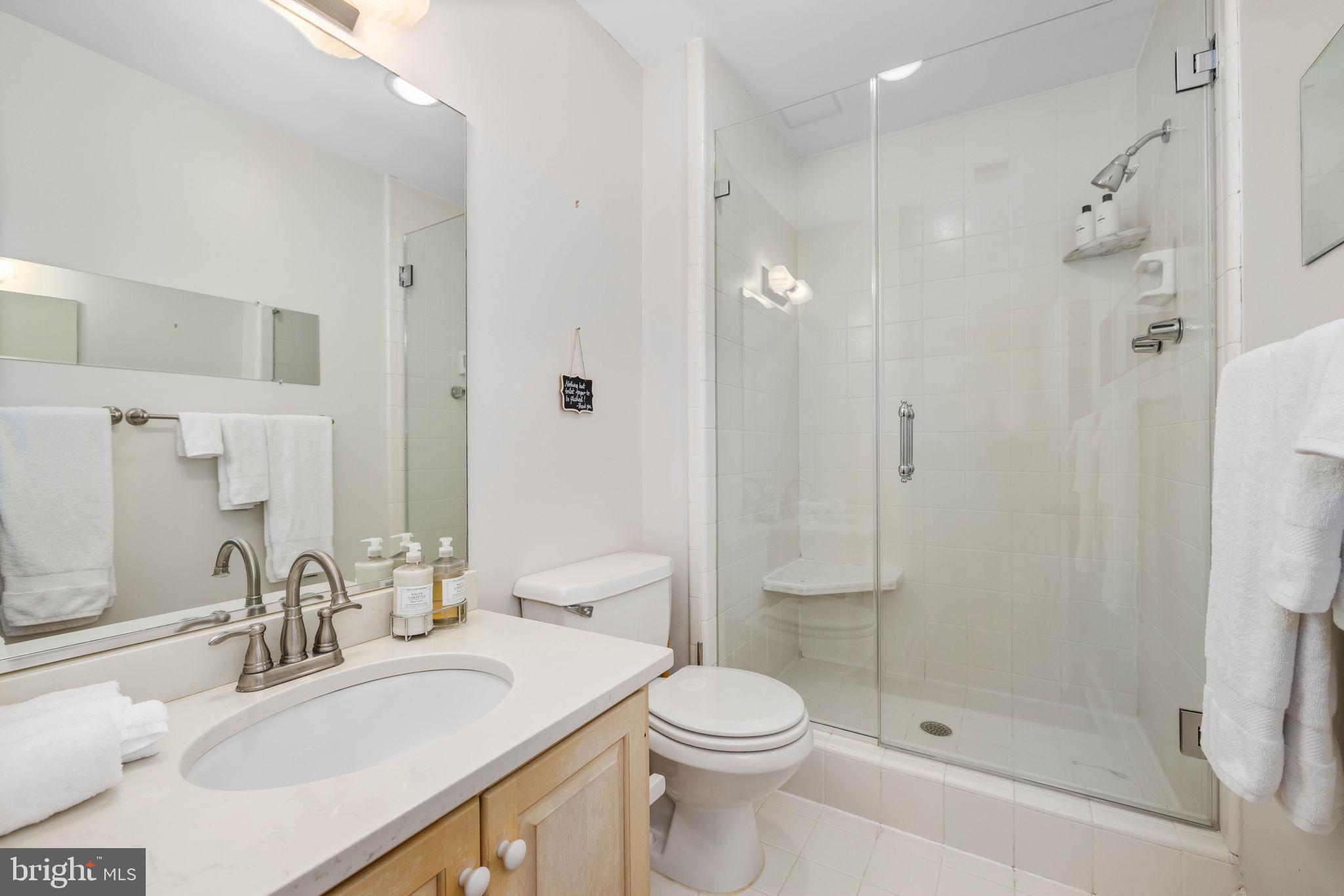 3408 Dent Place Northwest Washington, DC 20007 - Photo 12 of 17 a bathroom with a sink toilet vanity and shower