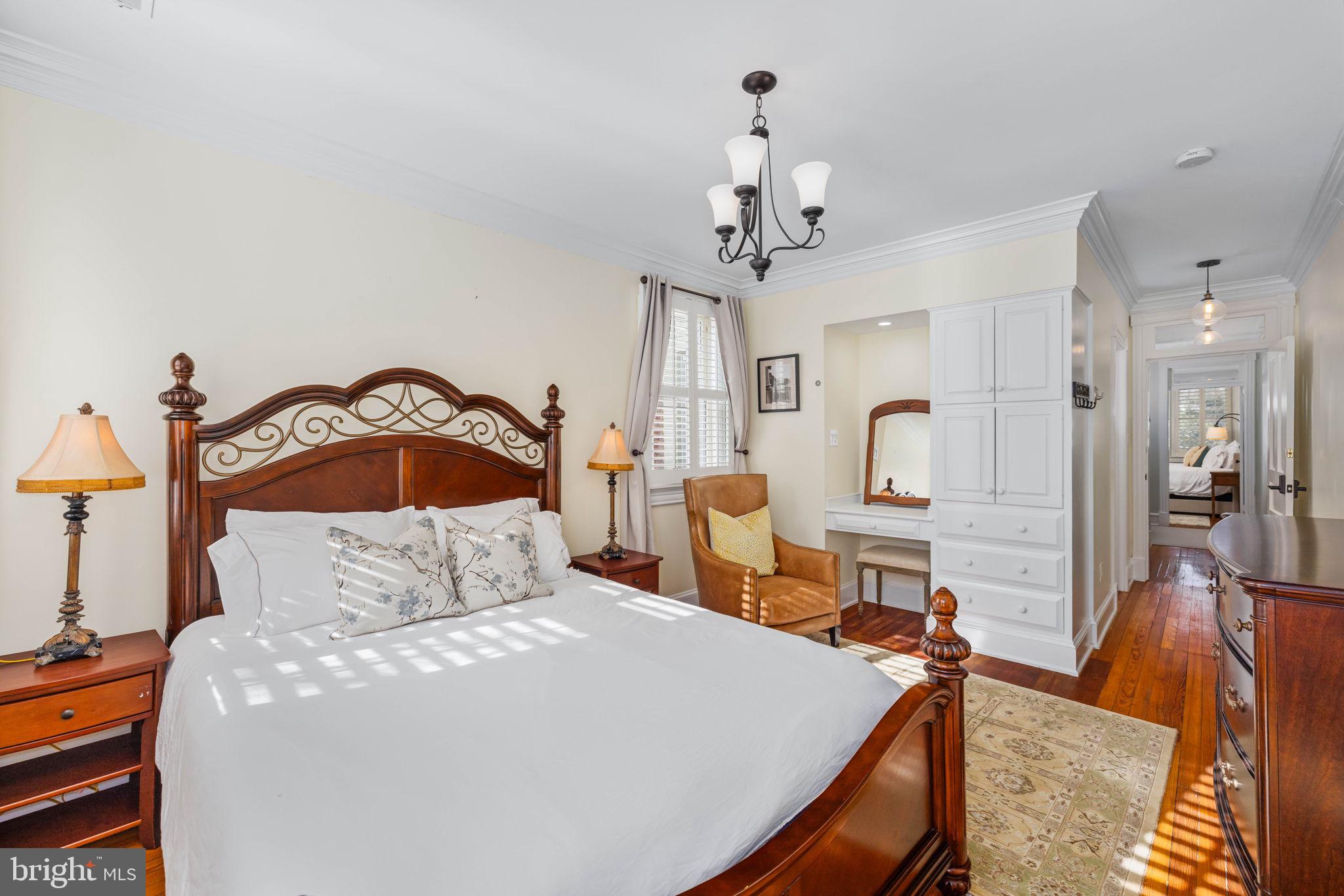 3408 Dent Place Northwest Washington, DC 20007 - Photo 14 of 17 a bedroom with a bed and a chandelier