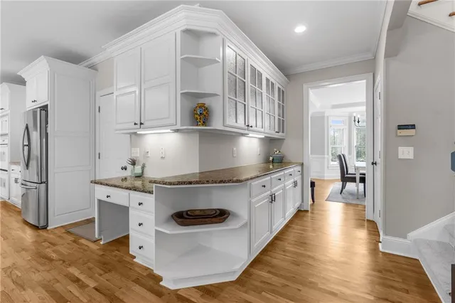 a kitchen with granite countertop a window a sink and a refrigerator