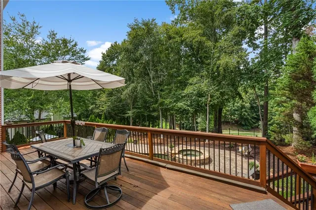 a view of a swimming pool with a patio and fire pit
