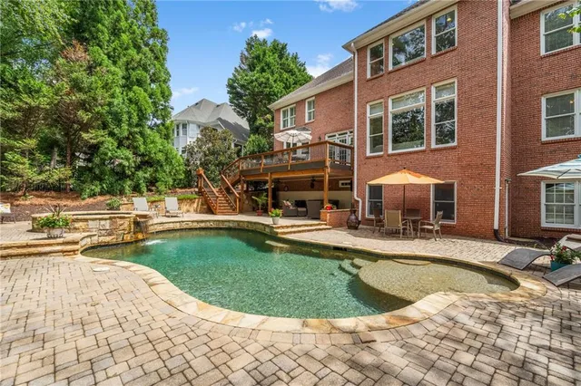 a view of a house with swimming pool and sitting area