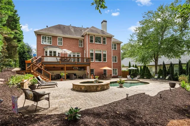 a front view of a house with swimming pool and sitting area