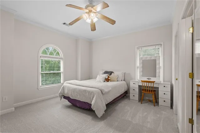 a spacious bedroom with a bed and window