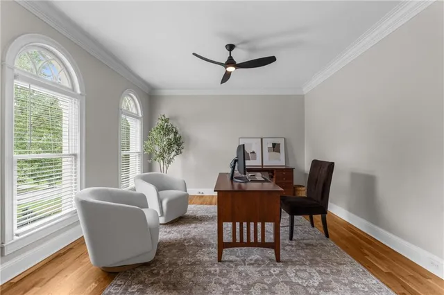 a view of a livingroom with wooden floor and furniture